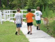 Some children walk a dog in one of Carolina Forest's many neighborhoods